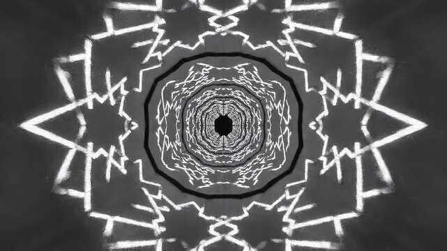 An abstract symmetrical black and white tunnel with radiating geometric patterns creates a.