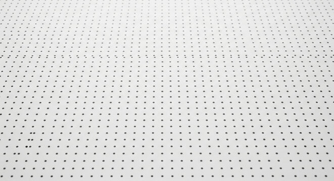 White textured surface with tiny black dots pattern, abstract background, perspective.