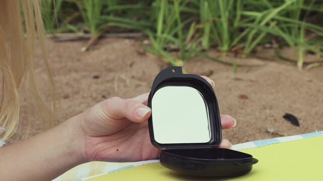 Clear dental aligners stored in modern black case on sandy beach during vacation, combining orthodontic care with travel, summer relaxation, dental hygiene and convenient portable treatment