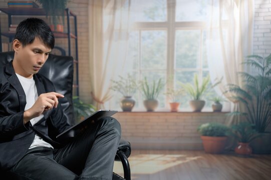 Young Man Working on Tablet in Bright Modern Living Room