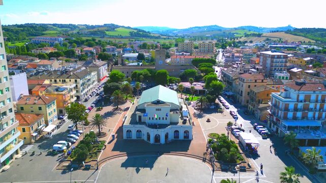 PORTO RECANATI, ITALY - JULY 30, 2025: Aerial pullback shot from Largo Porto Giulio. The Kursaal Lido, historic structure by the coast, was an elegant seaside resort, currently known as Cinema Kursaal