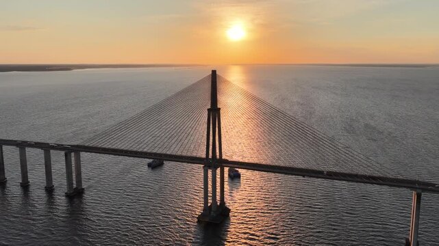 Sunset Cable Bridge At Manaus In Amazonas Brazil. Sunset Bridge. Boat Sailing. Amazon Black River. Cable Bridge In Manaus In Amazonas Brazil. Beautiful Sunset Skyline. Amazon Rainforest.