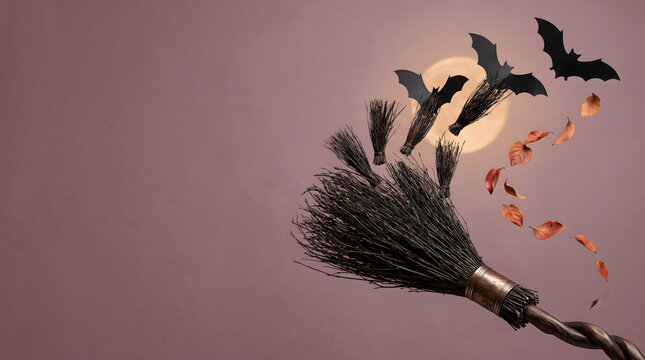 Witch broom transforming into flying bats for Halloween magic concept