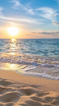 Peaceful tropical beach at sunset with gentle ocean waves washing onto soft sandy shore, glowing golden sunlight reflecting across the water, and a serene blue sky creating a relaxing coastal vacation