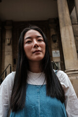 Fototapeta premium Asian woman portraying urban confidence in denim outfit