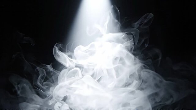 White smoke swirling in a bright spotlight against a black background. Abstract gas cloud rising into a beam of light. Atmospheric vapor effect for stage design.