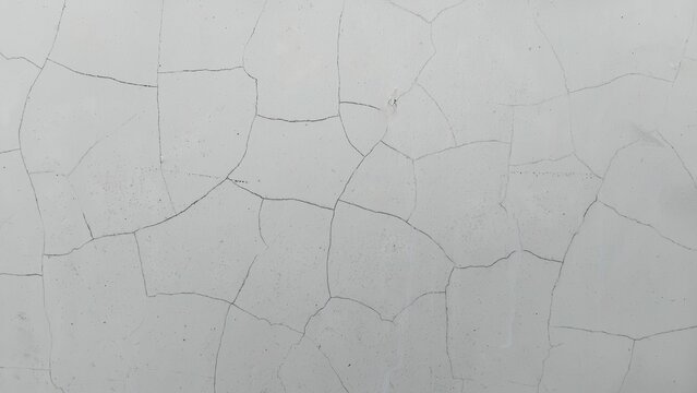 Cracked white wall surface texture close up for background