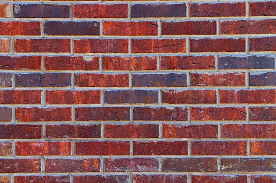 Background, texture of the wall of a residential building decorated with clinker bricks
