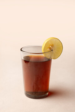 Glass of lemon tea with sliced lemon