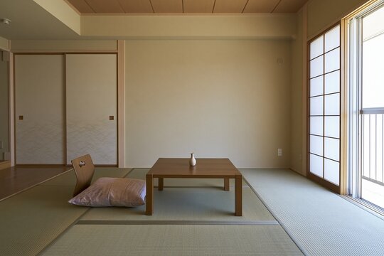 Sunlit tatami room with low table and floor cushions