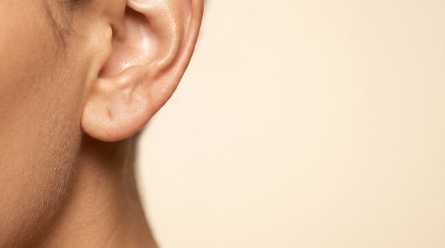 female ear and lobe close up for otology check and dermatology skin care photo