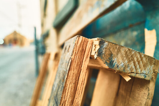 Splintered wooden pallet with traces of blue paint