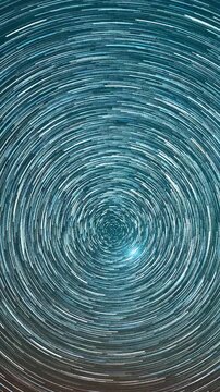 Ultra cinematic hyperlapse star trails spinning vortex in deep teal night sky concentric circular seamless loop time lapse