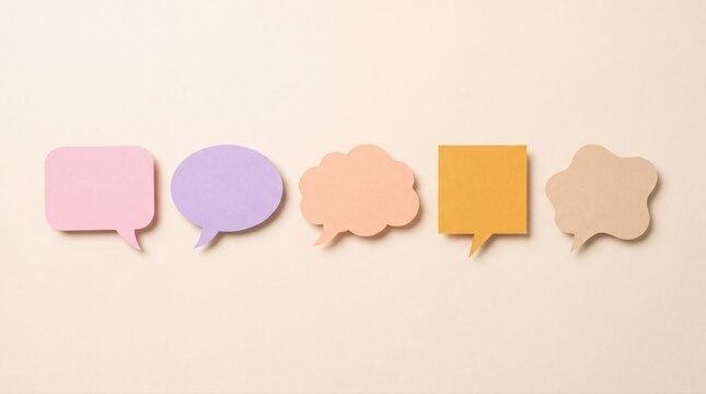 Pastel speech bubbles on beige background, colorful paper chat icons, social media concept