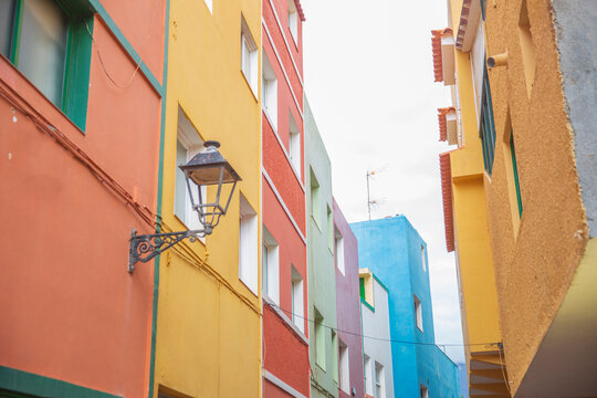 Bright colorful houses street in Villajoyosa old town Spain with retro lantern and copy space