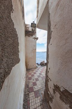 Narrow old street lane opening to Mediterranean Sea in Villajoyosa Spain with copy space