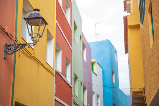 Close up of colorful Mediterranean houses with vintage street lamp in Villajoyosa Spain with copy space