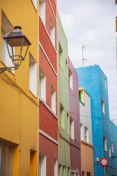 Vertical view of colorful houses in Villajoyosa Spain with blurred street lamp and copy space