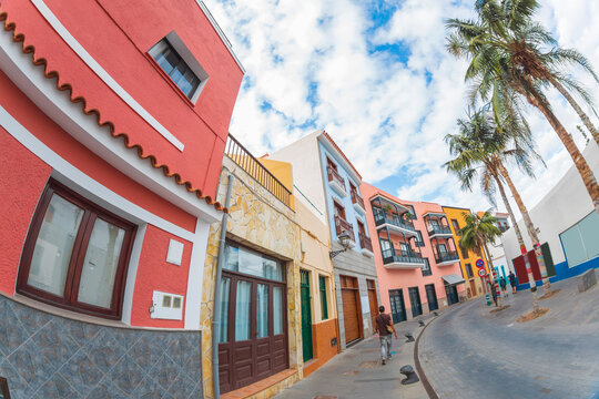 Tourist walking on colorful street in Puerto de la Cruz Tenerife with fisheye effect and copy space