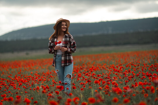 Woman poppies field smiling enjoying nature under a dramatic cloudy sky copy space