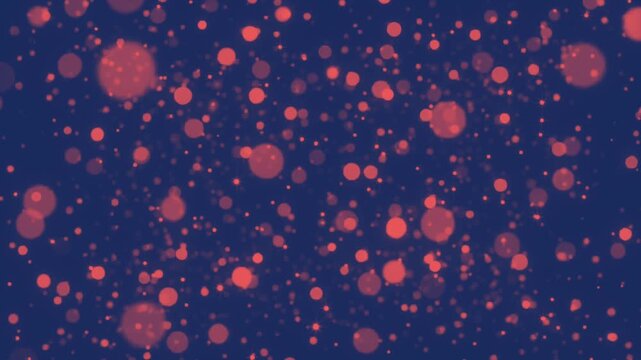 abstract background of glowing salmon colored bokeh particles drifting against a deep navy blue night sky