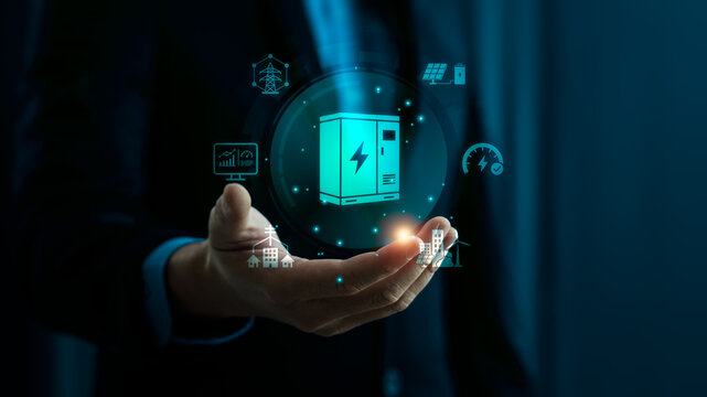 Smart grid and battery storage concept with business hand holding digital power cabinet interface showing renewable energy infrastructure solar electricity management and sustainable technology