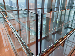 Fototapeta premium Spacious glass atrium with reflections on polished floor and panoramic windows. Empty lobby features