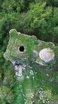 Vertical Drone View of Arakelots Monastery Hidden in Dense Forest.
