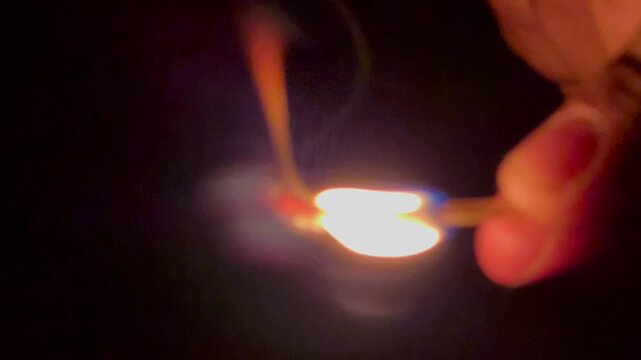 hand with burning matchstick fire