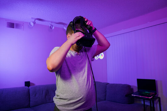 Man putting on VR headset before virtual gaming