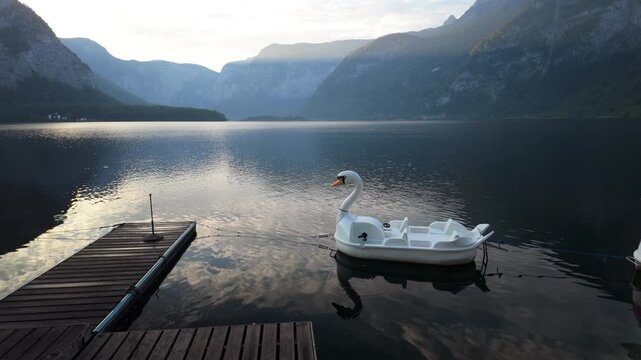 Swan paddle boats  moored at  Hallstatt lake in Austria.