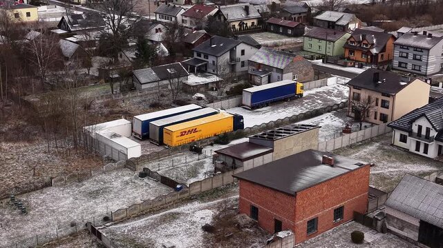 Courier transport trucks parked beside residential neighborhood 14.01.2026 Poland, Europe