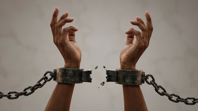 Hands with broken shackles representing freedom and liberation