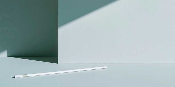 Minimalist white cane on a cool grey plaster surface with hard shadows and generous copy space for accessibility and healthcare concepts