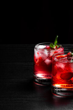Two Refreshing Red Berry Cocktails With Ice Fresh Mint and Strawberries