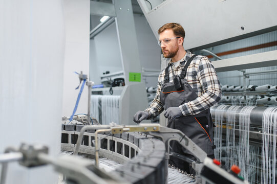 Worker monitoring polypropylene yarn production process on textile machine