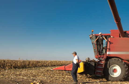 Farmers Working During Corn Harvest With Combine Harvester