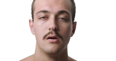 Naklejka premium Frontal Close-Up Studio Portrait of Exhausted Young Man Sweating from Extreme Heat