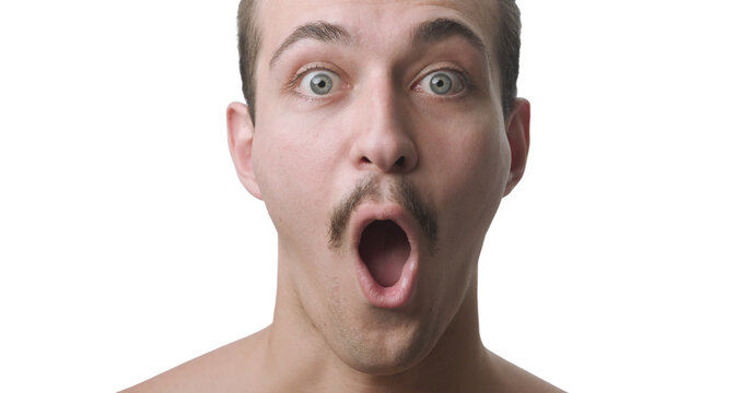Frontal Close-Up Portrait of Shocked Young Man with Open Mouth and Wide Eyes