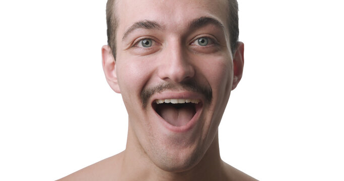 Frontal Close-Up Portrait of Happy Surprised Young Man Smiling with Open Mouth
