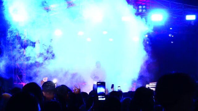 Concert Audience Watching an Overexposed Stage Light Show