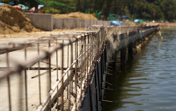 Building process city levee. Exposed foundation rebar grid at site, standing formwork and concrete footings