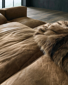 Close up texture of rough brown leather surface with fur throw