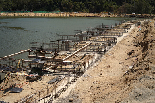 Building process city levee. Exposed foundation rebar grid at site, standing formwork and concrete footings