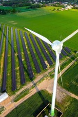 Fototapeta premium Solar panel farm and wind turbines producing clean green energy