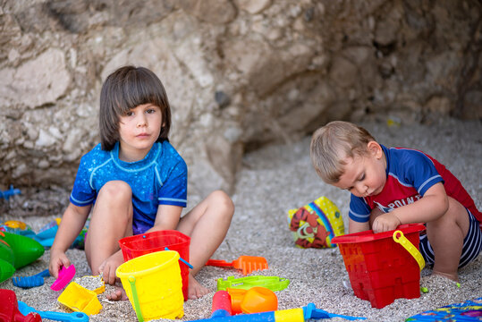 Children Playing with Beach Toys in the Sand
