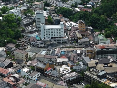 Aerial drone photo of mountain town streetscape in Kusatsu, Gunma, Japan