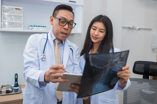 Doctor and nurse examine x-ray together
