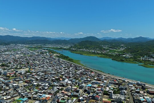 Aerial drone photo of river, bridges and residential area in Gobo City, Wakayama, Japan