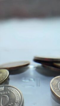 Ukrainian hryvnia and turkish lira coins falling and bouncing in slow motion representing the global economy, finance, and international currency exchange rates market